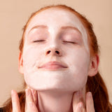 Model applying the Detoxifying Clay Masque. Skin is left clear, calm & soft. Suitable for sensitive skin.