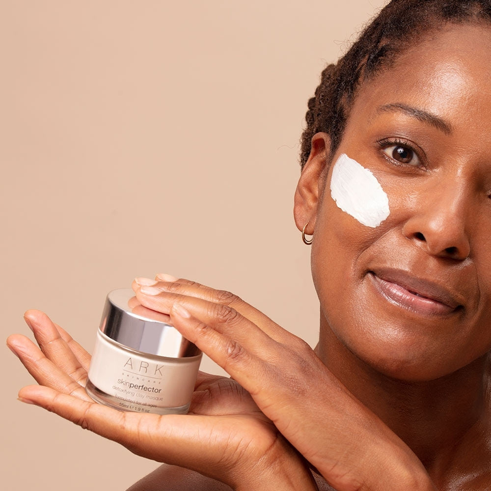 Model using ARK Skincare's Detoxifying Clay Masque. Luxurious dual clay formula. Cruelty free & 100% vegan