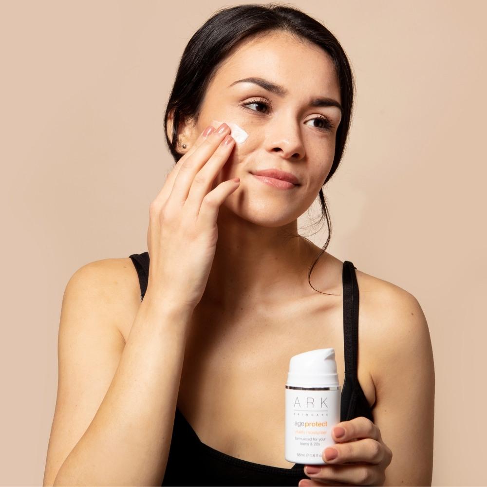 Model using ARK's Protect Moisturiser which helps to soothe irritations and protects from urban pollution
