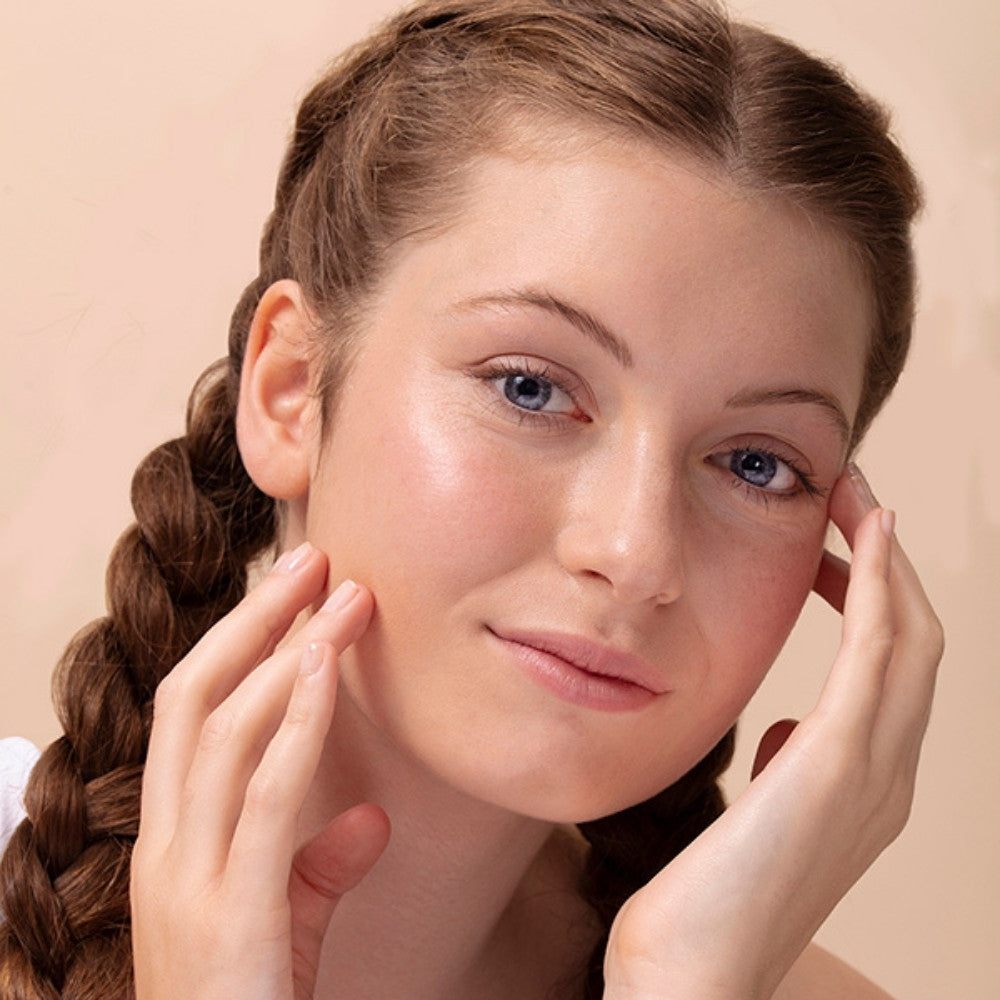 Model showing clear skin. Their radiant complexion due to using ARK's Protect Moisturiser. Vegan & cruelty free.