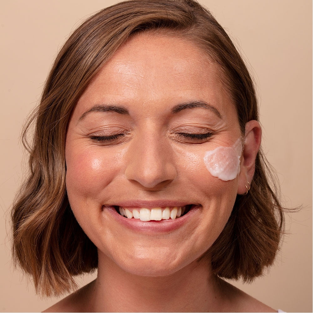 Model using ARK's Triple Action Exfoliator showing how it helps to smooth the skin leaving a bright, polished complexion