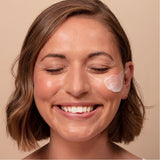 Model using ARK's Triple Action Exfoliator showing how it helps to smooth the skin leaving a bright, polished complexion