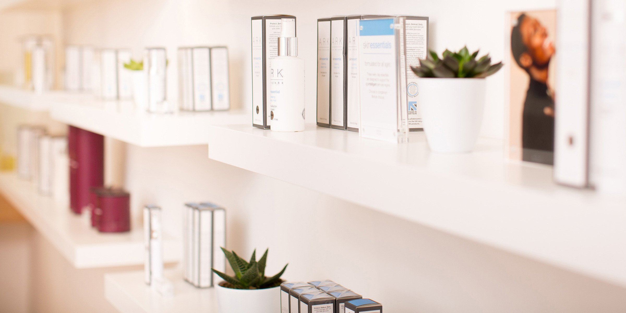 A closeup of ARK Skincare products on the shelves of the Boutique